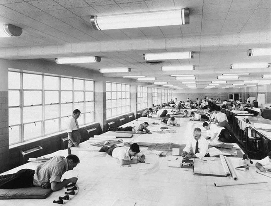 Room of engineers drafting on paper
